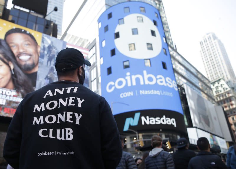 The Coinbase logo is displayed on screens in Times Square when Coinbase Global begins trading under the symbol COIN at the NASDAQ opening bell in New York City on April 14, 2021. Coinbase runs the largest bitcoin exchange in the U.S. and is the first major cryptocurrency-focused company to go public in the country. File photo by John Angelillo/UPI