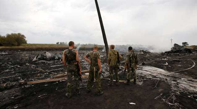 Armed pro-Russian separatists stand at the site of a Malaysia Airlines Boeing 777 plane crash near the settlement of Grabovo in the Donetsk region. The Malaysian airliner Flight MH-17 was brought down over eastern Ukraine. Photo: Reuters