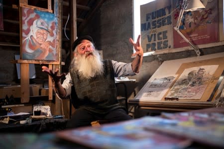 Michael Netzer, an American comics artist formerly named Mike Nasser, gestures during his interview with Reuters at his attic studio in his home in the Jewish settlement of Ofra in the Israeli-occupied West Bank