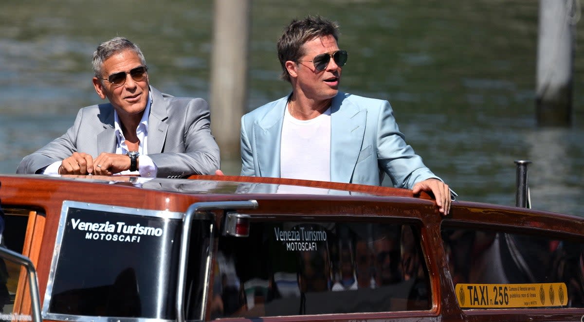 George Clooney and Brad Pitt arrive at the Lido Beach for the Venice International Film Festival on September 1, 2024 (EPA)