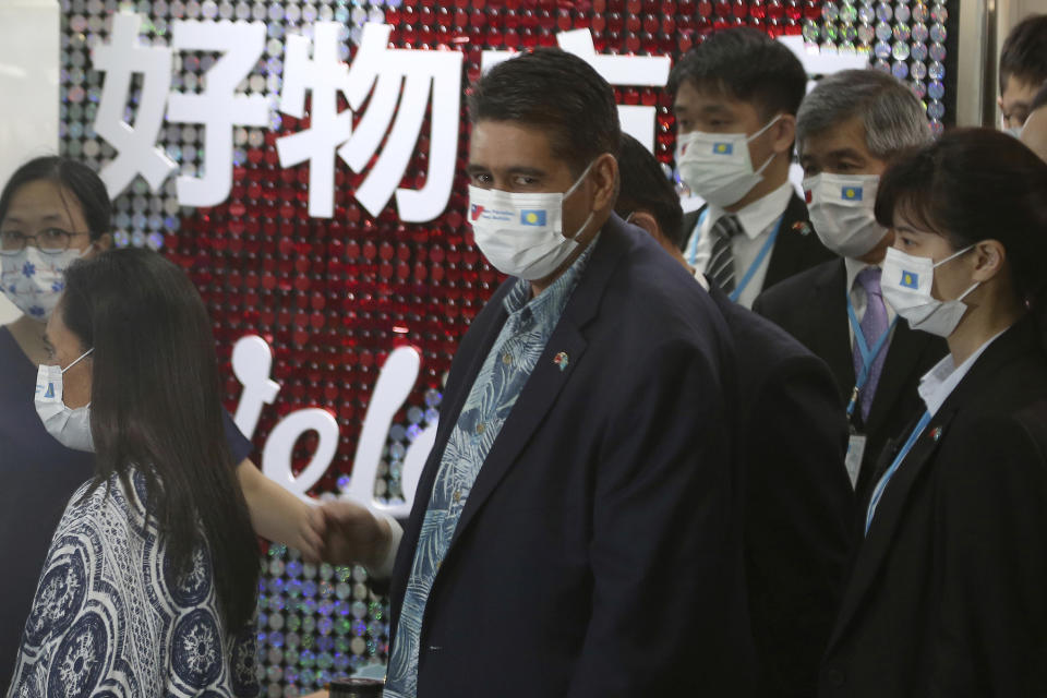 Palau President Surangel Whipps, center, lines up to take COVID-19 virus antigen test with Taiwanese travellers of the first group of Palau-Taiwan Travel Corridor before leaving Taiwan, at Taoyuan International Airport in Taoyuan, northern Taiwan, Thursday, April 1, 2021. The Palau-Taiwan Travel Corridor, allowing people to travel between the islands without a COVID-19 quarantine, has started Thursday. (AP Photo/Chiang Ying-ying)