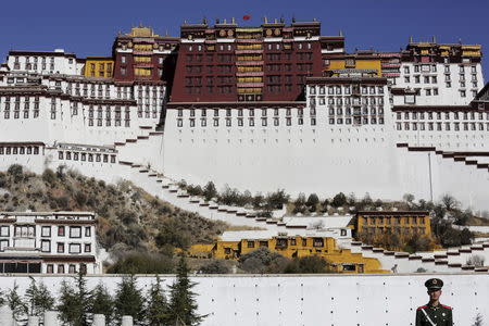 A paramilitary policeman stands guard in front of the Potala Palace in Lhasa, Tibet Autonomous Region, China in this November 17, 2015 file photo. REUTERS/Damir Sagolj/Files