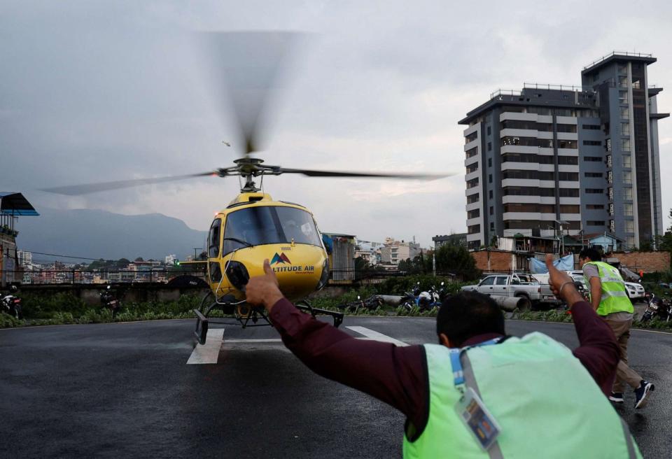 PHOTO: Officials air rush towards the helicopter carrying the body of the victims killed in a helicopter crash, at Tribhuvan University Teaching Hospital in Kathmandu, Nepal, July 11, 2023. (Navesh Chitrakar/Reuters)