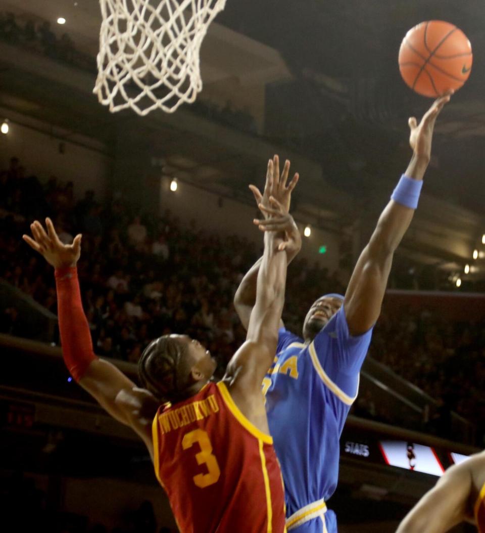 UCLA's Adem Bona goes up for a basket over USC's Vincent Iwuchukwu at the Galen Center on Saturday.