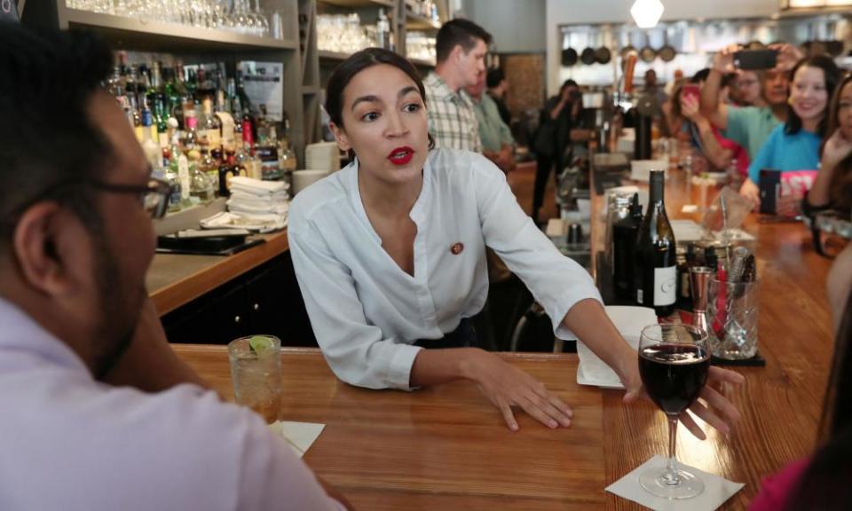 Alexandria Ocasio-Cortez serves drinks in support of One Fair Wage at the Queensboro restaurant in Queens, New York, on 31 May 2019.