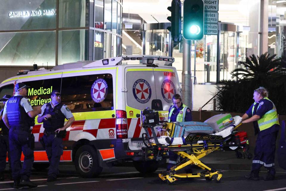 <p>DAVID GRAY/AFP via Getty</p> Paramedics respond to the Westfield Bondi Junction in Sydney on April 13