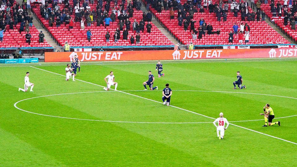 England and Scotland players, pictured here taking a knee before their Euro 2020 match.