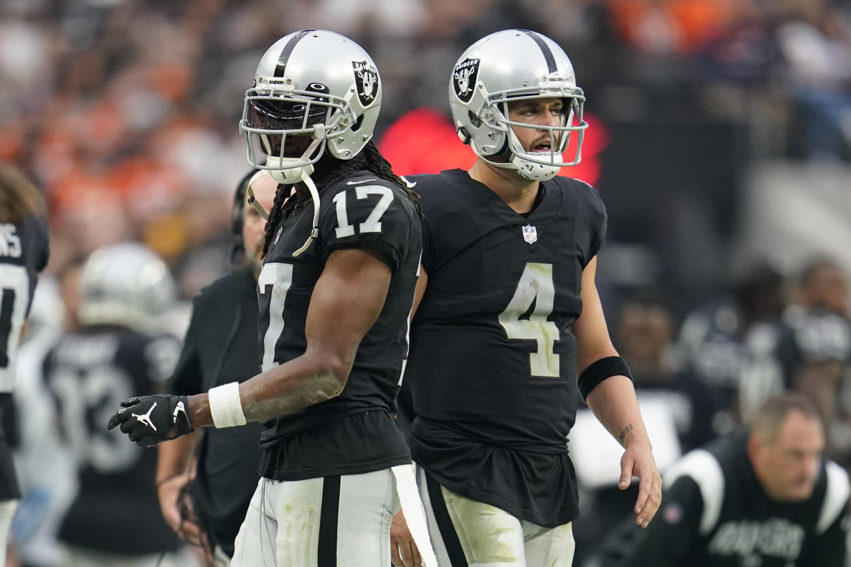 FILE - Las Vegas Raiders wide receiver Davante Adams (17), left, and quarterback Derek Carr (4), right, look on from the sidelines during the second half of an NFL football game against the Denver Broncos, Sunday, Oct. 2, 2022 in Las Vegas. The chemistry the two had once shared figured to help the Raiders' offense becomes among the league's elite. That hasn't happened. (AP Photo/Abbie Parr)