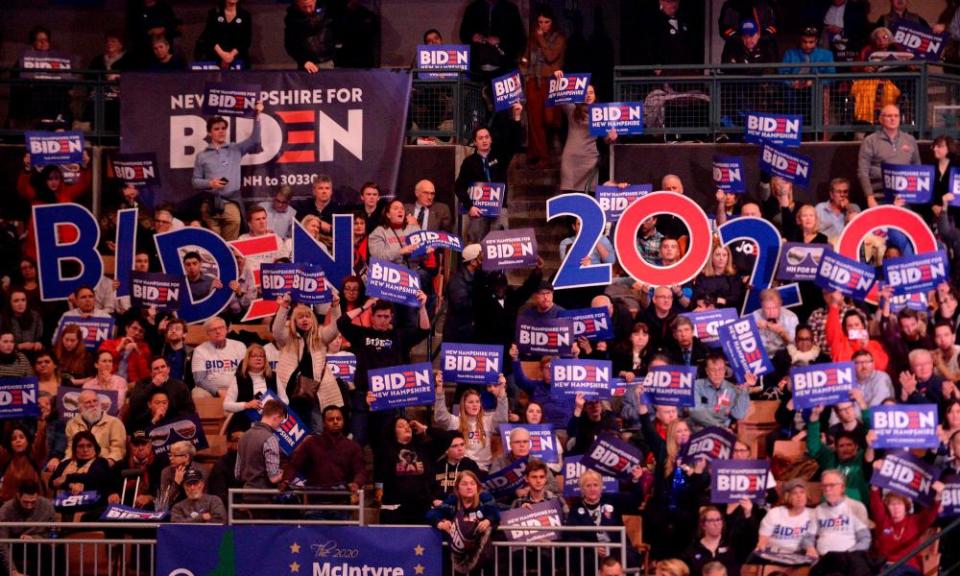 Supporters of Joe Biden hold signs at the Democratic party’s McIntyre-Shaheen 100 Club dinner in Manchester, New Hampshire, on 8 February.