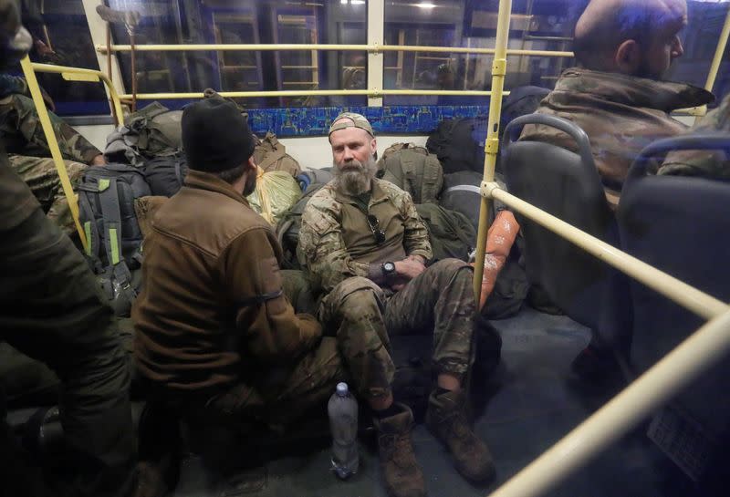 Buses carrying service members of Ukrainian forces who have surrendered after weeks holed up at Azovstal steel works arrive in Olenivka