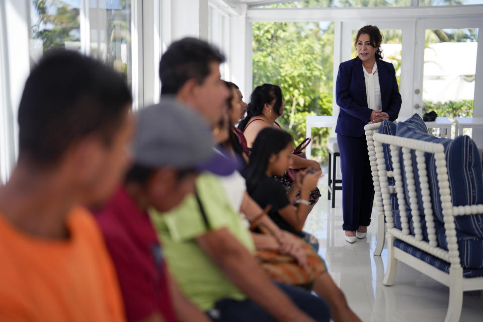 Activist Nora Sandigo speaks to Mexican immigrants who have lived and worked for years or decades in the U.S. without being able to get work permits or access to other benefits of legal status, such as being able to travel to their home countries to visit family and return, Tuesday, Nov. 7, 2023, in Miami. (AP Photo/Rebecca Blackwell)