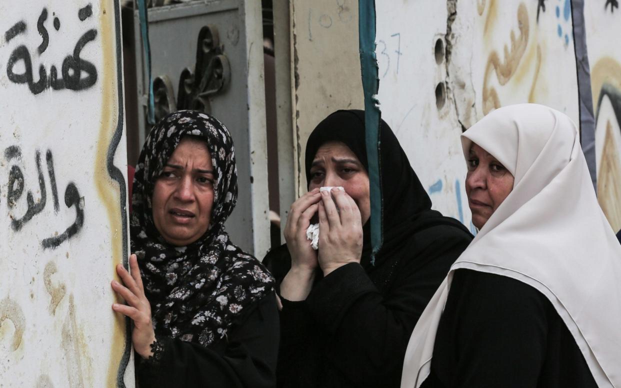 Relatives of 15-year-old Palestinian boy Othman Rami Halles mourn during his funeral in Gaza City - AFP