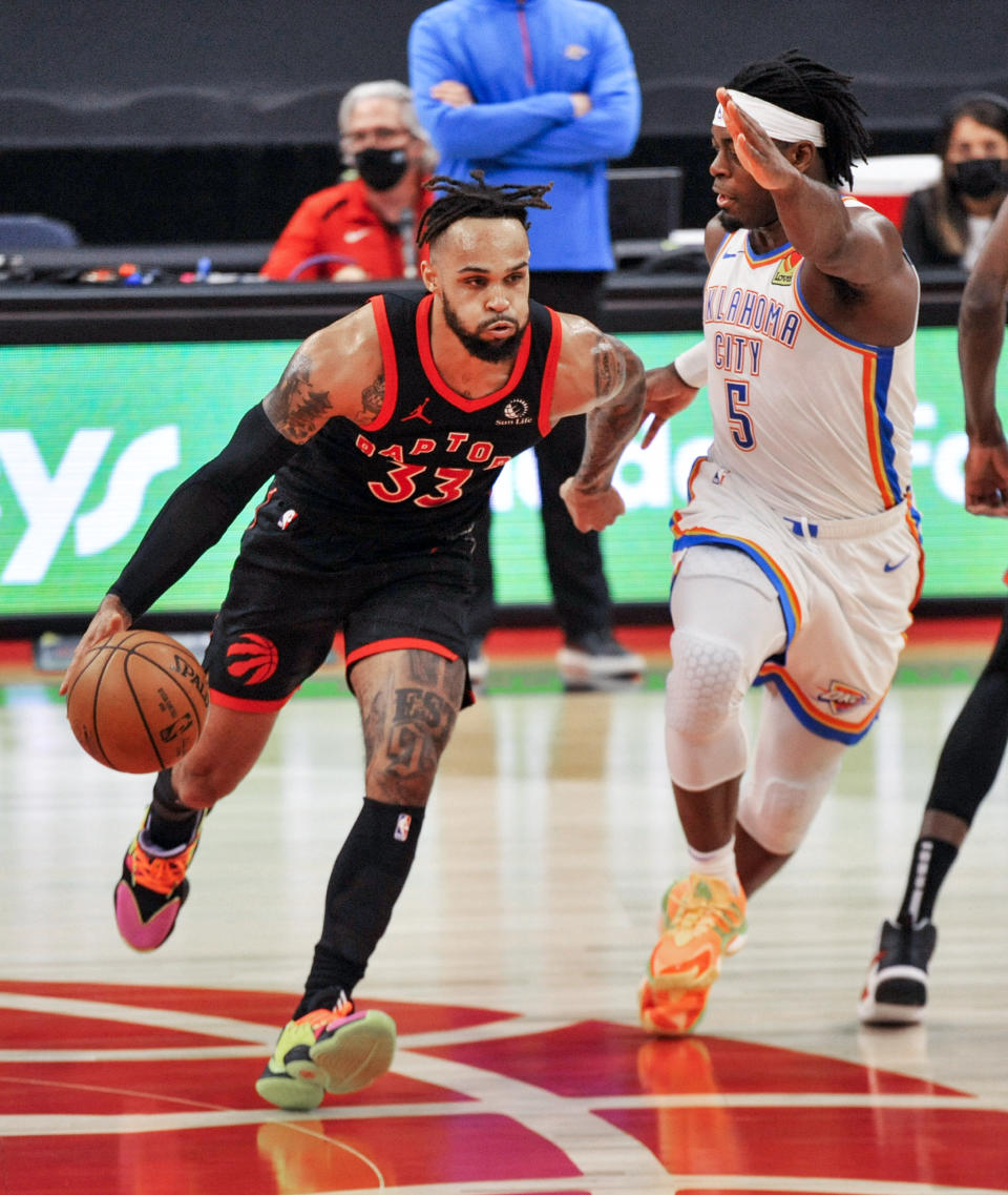 Toronto Raptors' Gary Trent Jr., left, dribbles under pressure from Oklahoma City Thunder's Luguentz Dort, right, during the third quarter of a basketball game Sunday, April 18, 2021, in St. Petersburg, Fla. (AP Photo/Steve Nesius)