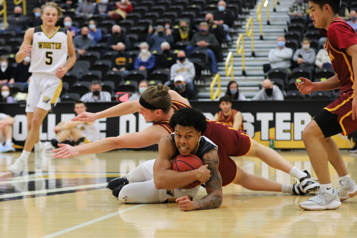 The College of Wooster's Najee Hardaway battles for a loose ball during the Fighting Scots' victory over Oberlin College at Timken Gymnasium Wednesday night.