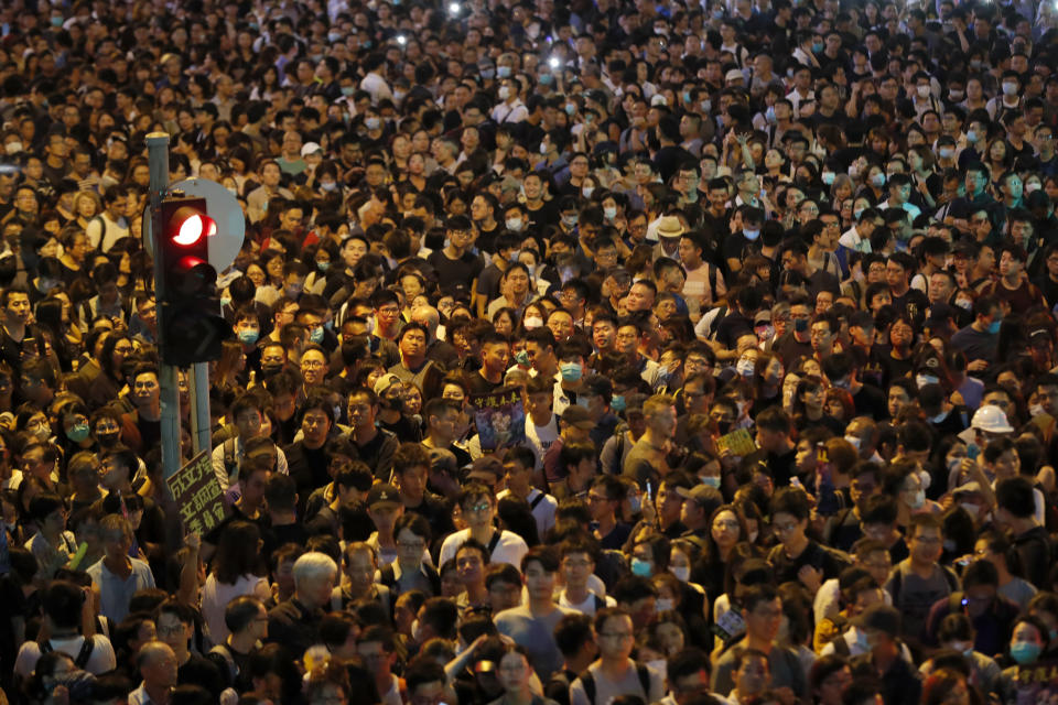 Protesters gather at a demonstration by civil servants in Hong Kong Friday, Aug. 2, 2019. Protesters plan to return to the streets again this weekend, angered by the government's refusal to answer their demands, violent tactics used by police - possibly in coordination with organized crime figures. (AP Photo/Vincent Thian)