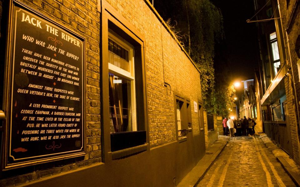 A guided tour in an alley outside The White Hart Pub in east London