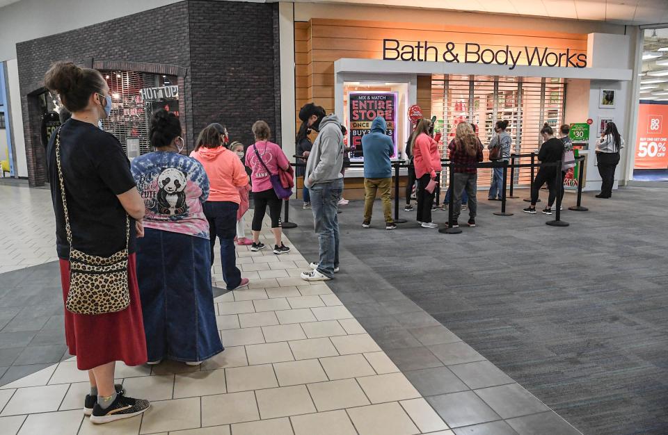 People line up for Bath & Body Works to open at 7 a.m. during Black Friday shopping.