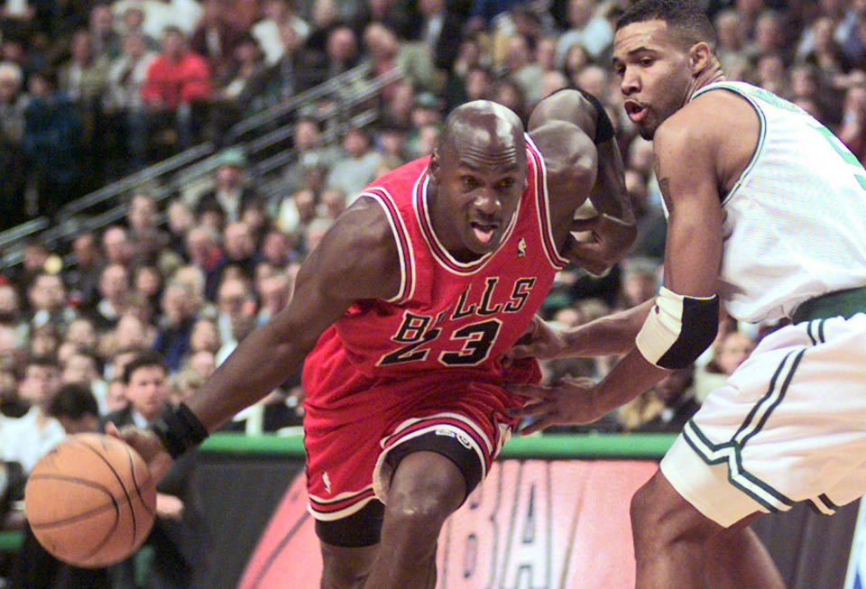 FILE - In this Oct. 31, 1997, file photo Chicago Bulls guard Michael Jordan (23) drives past Boston Celtics Ron Mercer (5) during an NBA basketball game in Boston.  A Bismarck, N.D., man who used to own McDonald's restaurants is about $10,000 richer after selling a 20-year-old container of McJordan barbecue sauce Monday, Oct. 15, 2012, to a buyer in Chicago. The sauce was used on McJordan Burgers, named for basketball icon in limited markets for a short time in the 1990s, when Jordan led the Chicago Bulls to six NBA championships. (AP Photo/Stephan Savoia, file)