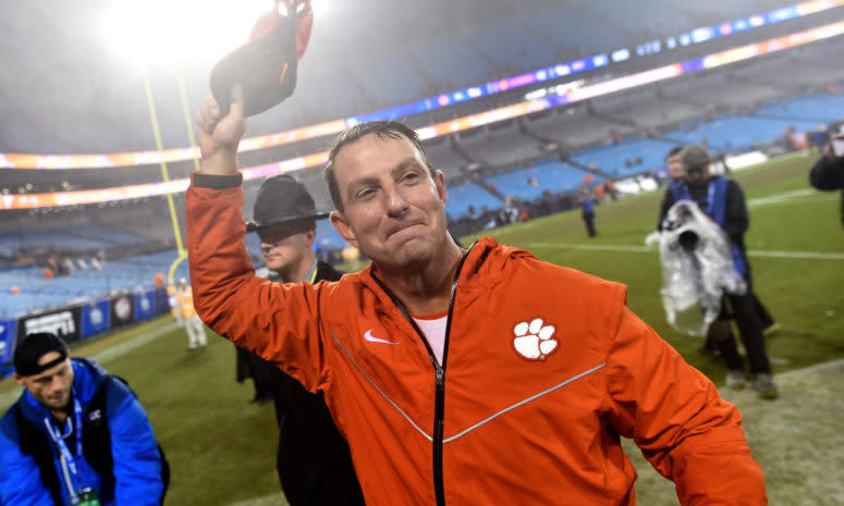 Dabo Swinney greets a Clemson football fan in the crowd.