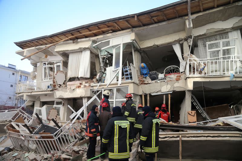 Rescuers work on a damaged building after an earthquake in Elazig