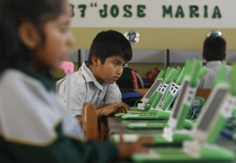 In this June 8, 2012 photo, a boy uses his laptop at the Jose Maria public school in a shantytown on the outskirts of Lima, Peru. Peru has sent more than 800,000 laptop computers children across the country, one of the world’s most ambitious efforts to leverage digital technology in the fight against poverty. Yet five years into the program, there are serious doubts about whether the largest single deployment in the One Laptop Per Child initiative was worth the more than $200 million that Peru’s government spent. (AP Photo/Karel Navarro)