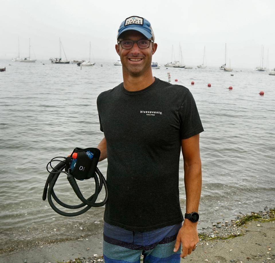 Ultra swimmer Ben Tuff holds the Ocean Guardian's Freedom 7 electronic shark repellent he will wear for his 19-mile, Block Island to Jamestown, swim on Sunday.   [The Providence Journal / Kris Craig]