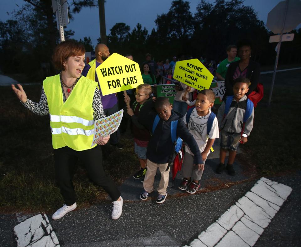 Jessie Driggers of Safe Kids Marion, left, talks to Greenway Elementary School students about safety during the annual Walk To School Day in 2018.