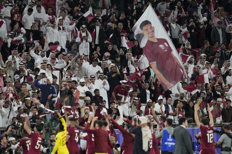 Qatar supporters celebrate at full time of the Asian Cup semifinal soccer match between Iran and Qatar at Al Thumama Stadium in Doha, Qatar, Wednesday, Feb. 7, 2024. Qatar won 3-2. (AP Photo/Aijaz Rahi)