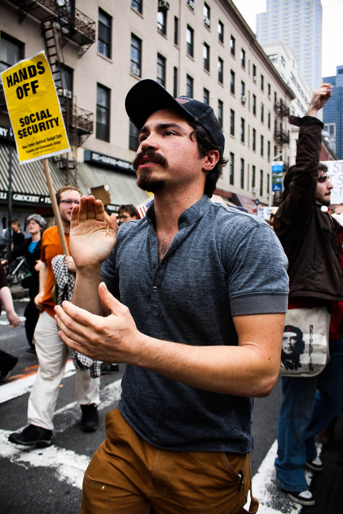 A man claps while marching