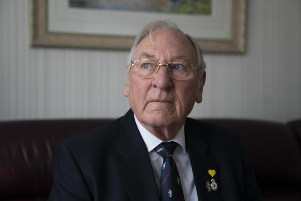 Major Gordon Bonner poses for a photo at his home in Leeds, England, Saturday Jan. 23, 2021. For nine months, Bonner has been in the "hinterlands of despair and desolation" after losing Muriel his wife of 63 years to the coronavirus pandemic that has now taken the lives of more than 100,000 people in the United Kingdom. ( AP Photo/Jon Super)