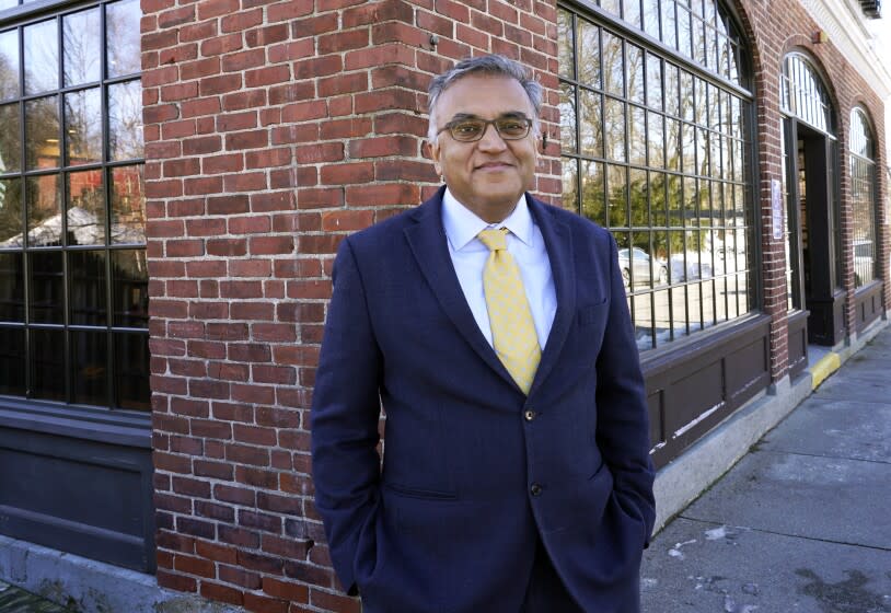 FILE - Dr. Ashish Jha, dean of Brown University's School of Public Health, poses for a photo Dec. 23, 2020, in Newton, Mass. President Joe Biden's COVID-19 coordinator Jeff Zients and his deputy Natalie Quillian are leaving the administration next month, the White House announced Thursday, March 17, 2022. They will be replaced by Dr. Ashish Jha. (AP Photo/Elise Amendola, File)