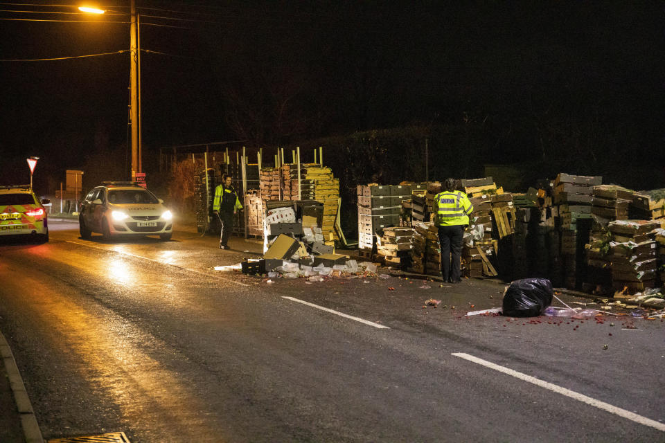 Wooden pallets full of fruit and vegetables are left strewn across the A38 into North Petherton after a member of public reported seeing several people coming out of a lorry on the road resulting in a police investigation and numerous arrests on suspicion of immigration offences. Somerset. 16 January 2020.   See SWNS story SWBRlorry