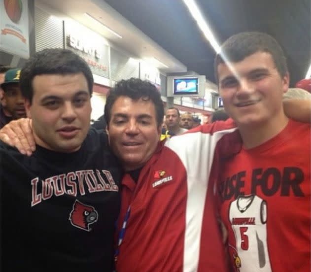 Papa John's CEO John Schnatter (center) with friendly sports fans in 2013. (Photo: unknown)