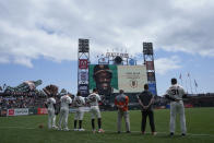 San Francisco Giants players and staff observe a moment of silence for late former player Vida Blue before a baseball game between the Giants and the Milwaukee Brewers in San Francisco, Sunday, May 7, 2023. (AP Photo/Jeff Chiu)
