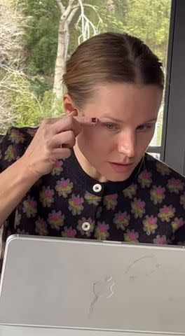 <p>Kristen Bell/Instagram</p> Bell attempting to stick silver rhinestones to her eyes.