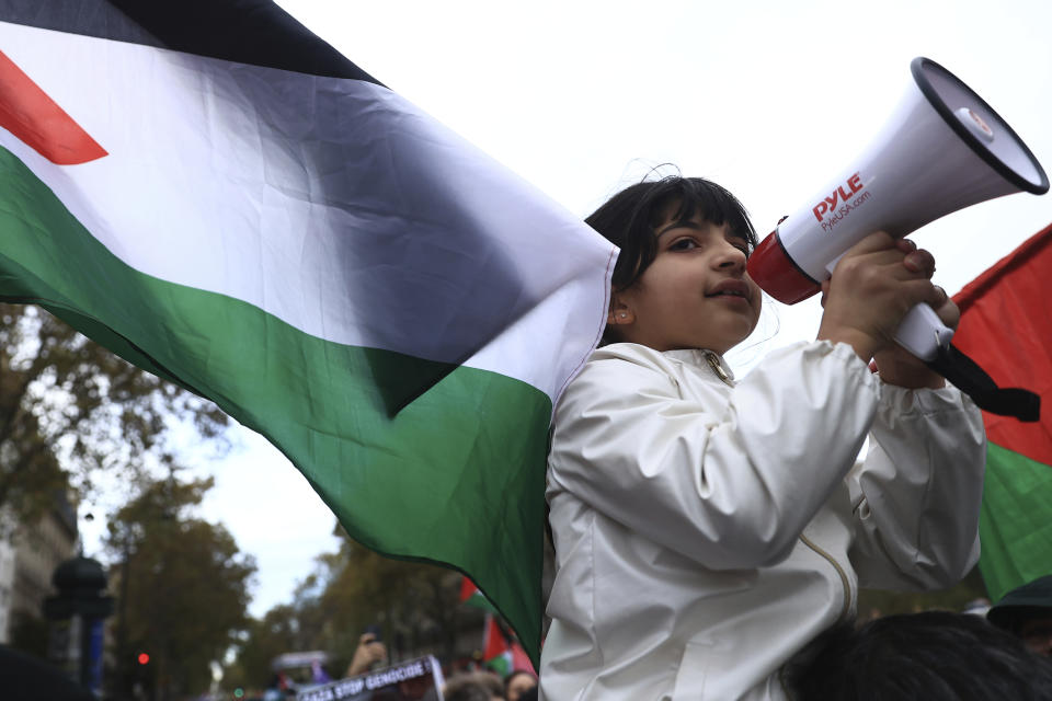 A young protester takes part in a demonstration to support the Palestinian people in Gaza, Saturday, Nov. 4, 2023 in Paris. (AP Photo/Aurelien Morissard)