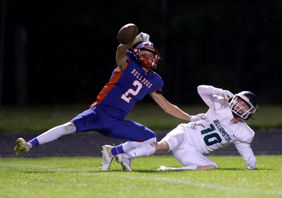Mason's Nick Wells, left, knocks down a Williamston pass intended for Max McCune, right, after they both got tangled up and fell, Friday, Sept. 15, 2023, in Mason.