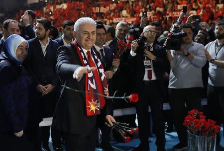 Turkish Prime Minister and leader of the ruling AK Party Binali Yildirim greets his supporters during a campaign meeting for the April 16 constitutional referendum, in Ankara, Turkey, February 25, 2017. REUTERS/Umit Bektas
