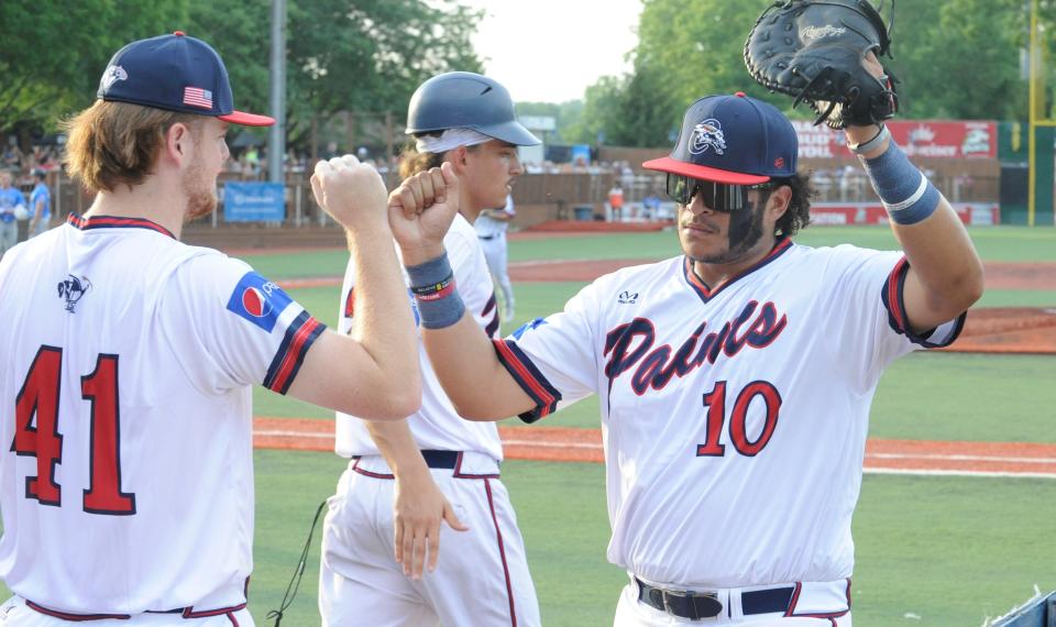 Chillicothe Paints first baseman Victor Figueroa (#10) fist bumps teammate Jared Adams (#41) during the Paints' 11-1 win over REX Baseball at VA Memorial Stadium on June 30, 2023.