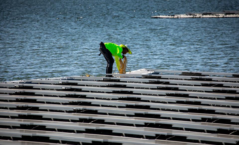 Crews will construct and assemble the floating solar arrays on land in segments before securing them with anchors in the water.