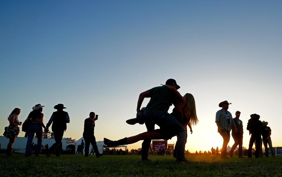 Katie Boyle and Rhys Freitas dance as the sun sets at Country Thunder Music Festival near Florence on April 14, 2023.
