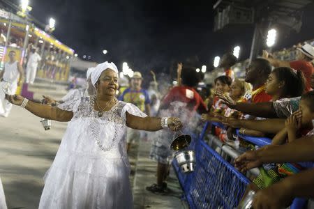 Women dressed in Baianas perform the traditional "Lavagem", or washing ritual, to bring good luck at the Sambodrome, one week before the Carnival parade, in Rio de Janeiro February 8, 2015. REUTERS/Pilar Olivares