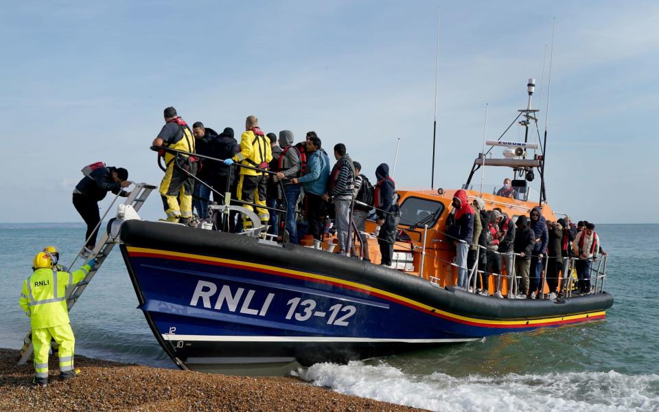 A group of migrants arrive in Dungeness, Kent, after being rescued in the Channel by the RNLI - Gareth Fuller/PA