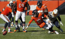 Chicago Bears quarterback Mitchell Trubisky (10) fumbles the ball in front of Los Angeles Chargers defensive end Damion Square (71) during the second half of an NFL football game, Sunday, Oct. 27, 2019, in Chicago. The Chargers won 17-16. (AP Photo/Charles Rex Arbogast)