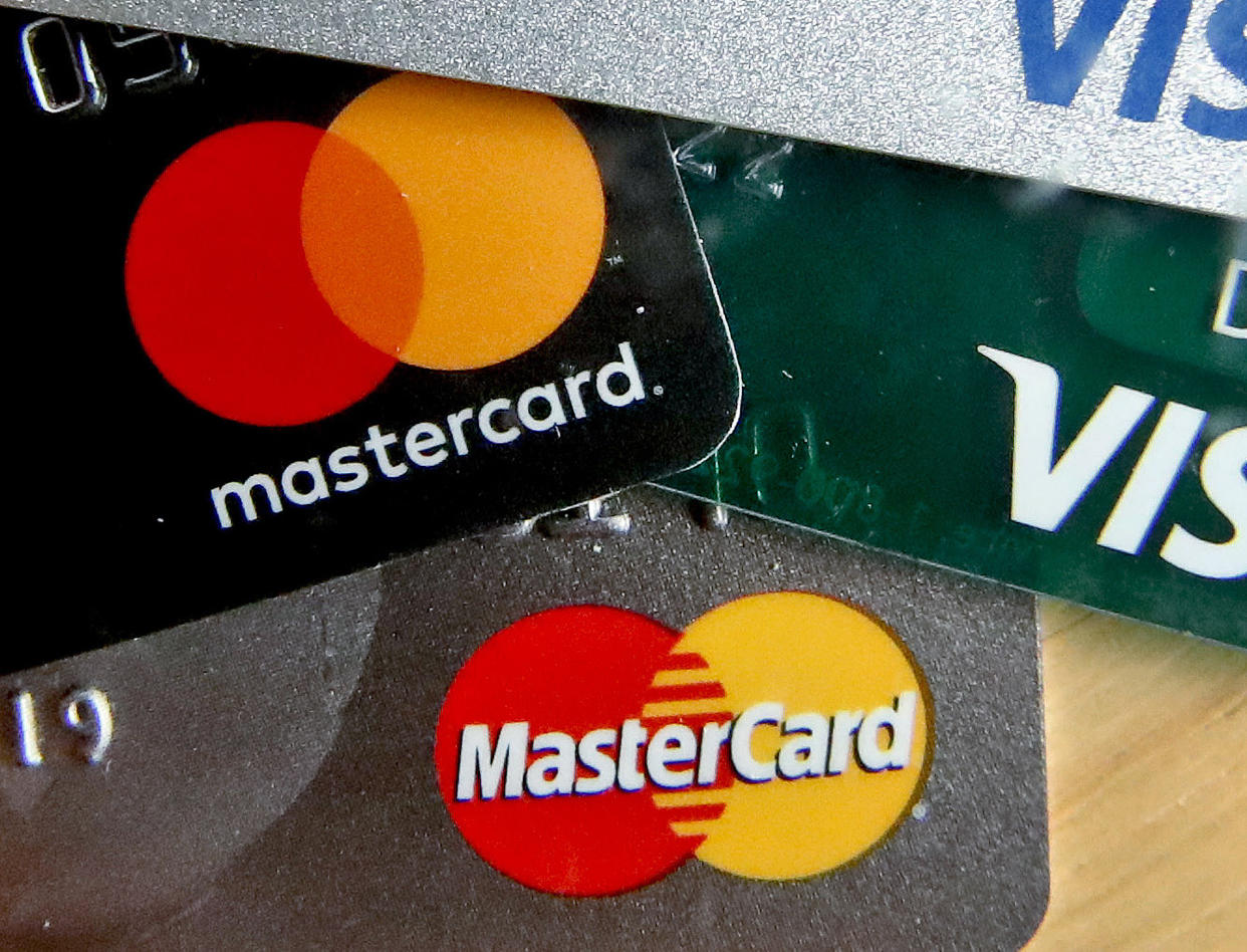 FILE - In this Feb. 20, 2019, file photo are Mastercard and Visa credit cards in Zelienople, Pa. Americans gave their credit cards a real workout this past holiday season. The Federal Reserve said Friday, Feb. 7, 2020, that borrowing on credit cards rose by the largest amount in more than two decades in December. (AP Photo/Keith Srakocic, File)