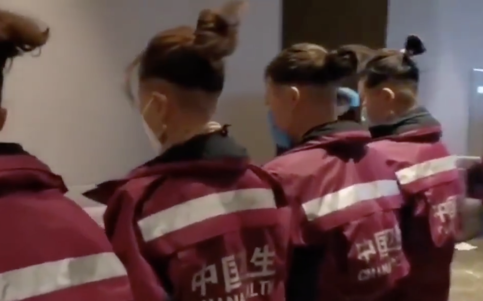 Nurses with the backs of their heads shaven.