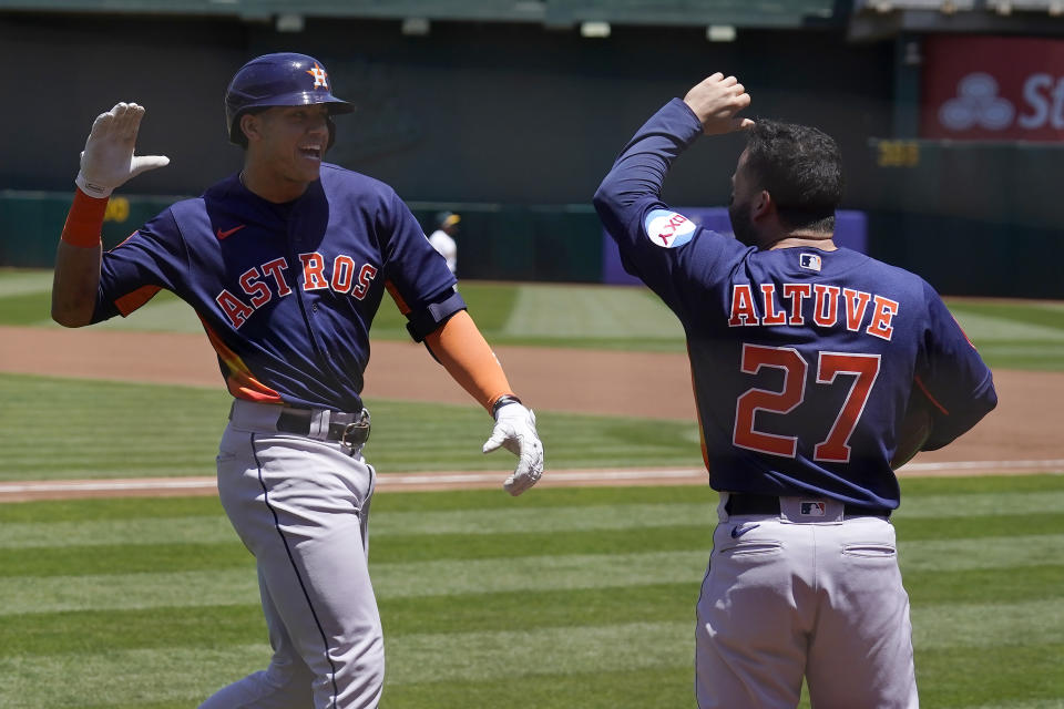 Houston Astros' Jeremy Pena, left, celebrates after hitting a two-run home run that also scored Jose Altuve (27) during the first inning of a baseball game against the Oakland Athletics in Oakland, Calif., Saturday, May 27, 2023. (AP Photo/Jeff Chiu)