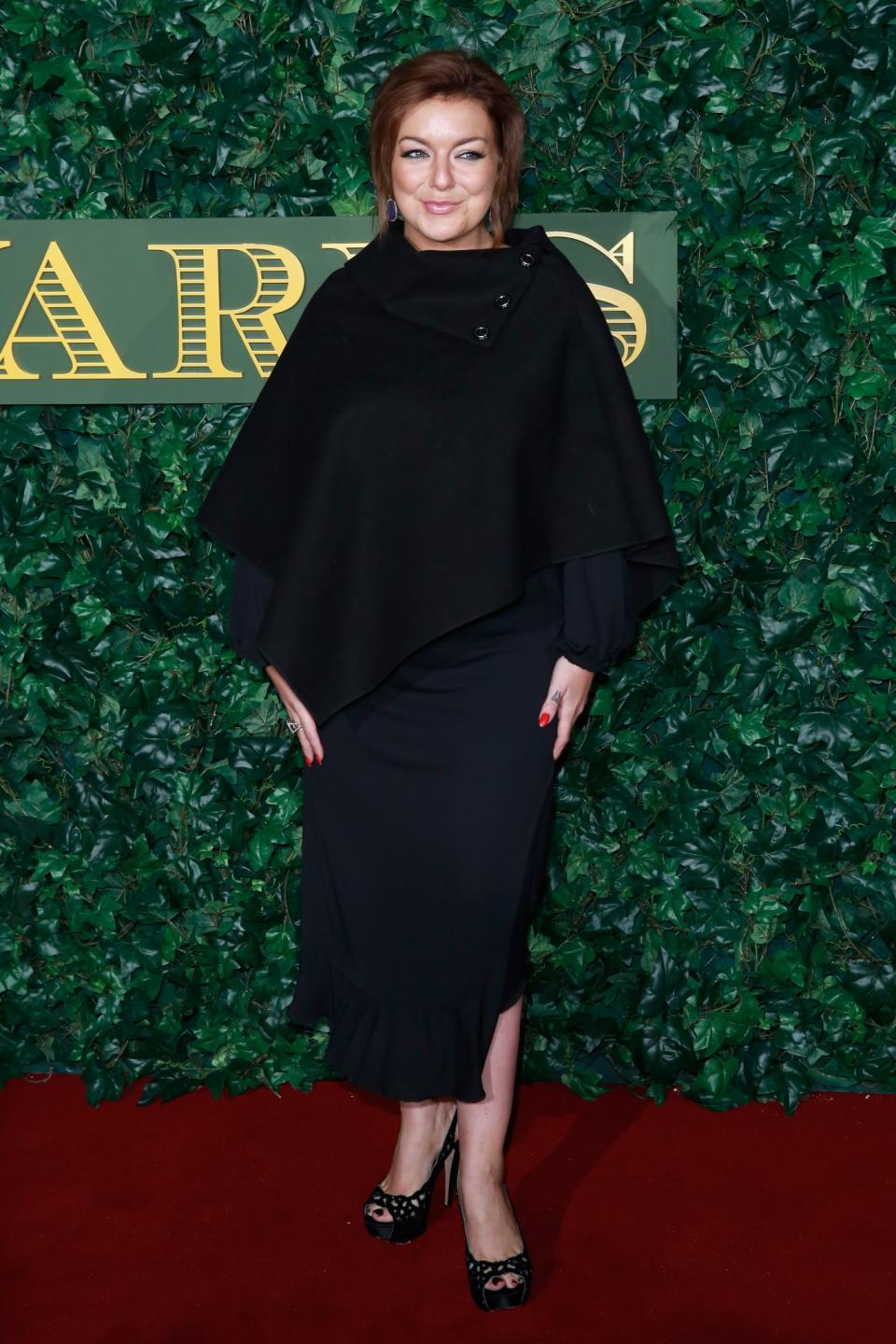 <p>The star of the stage was dressed in all black for the event, wearing a knitted cape, dark dress and coordinating sandals. <i>[Photo: Getty]</i> </p>