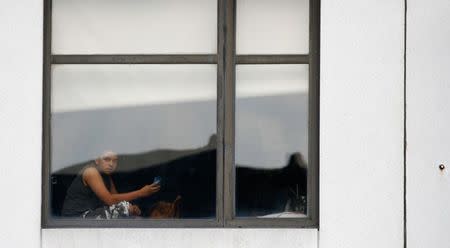 A child looks out the window of the hospital after an incident in which a gunman fired shots inside the Bronx-Lebanon Hospital in New York City, U.S. June 30, 2017. REUTERS/Brendan Mcdermid
