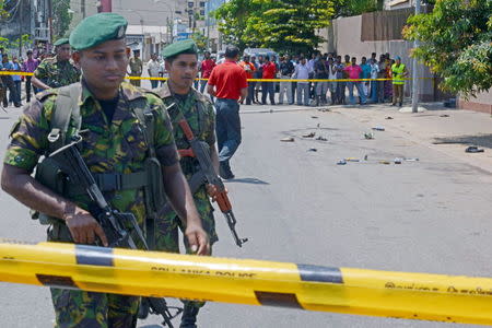 Special Task Force soldiers stand guard near the site of a shooting at an election rally in Colombo July 31, 2015. REUTERS/Stringer